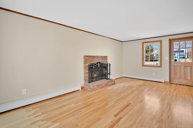 unfurnished living room with a brick fireplace, wood-type flooring, ornamental molding, and baseboard heating