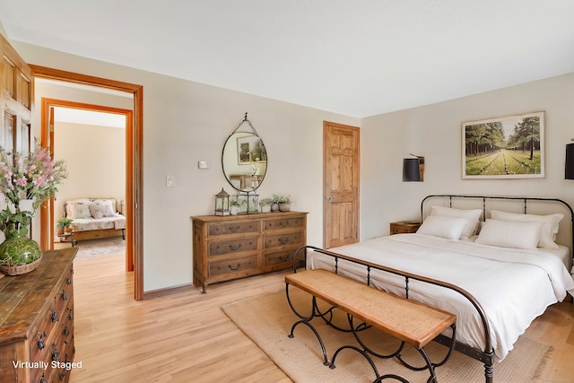 bedroom with baseboards and light wood-style floors