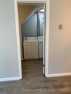 corridor with washing machine and clothes dryer and baseboards