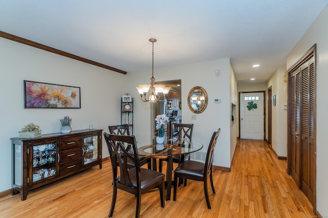 dining space featuring light wood finished floors, a notable chandelier, recessed lighting, and baseboards