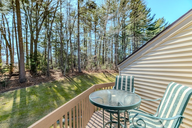 wooden terrace featuring a yard