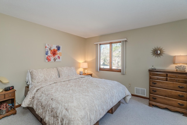 carpeted bedroom featuring visible vents and baseboards