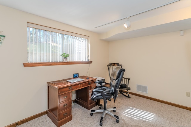 office space featuring visible vents, carpet flooring, rail lighting, and baseboards