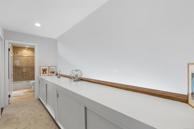 interior space featuring recessed lighting, vaulted ceiling, and light colored carpet