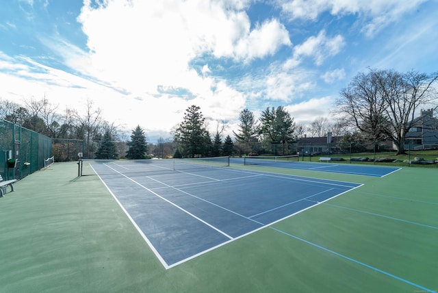 view of sport court featuring fence