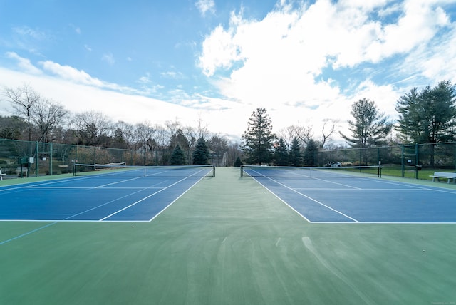 view of tennis court with fence