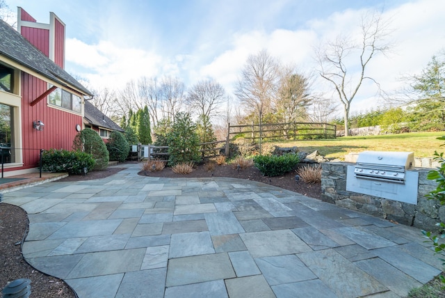 view of patio / terrace featuring a grill, fence, and area for grilling