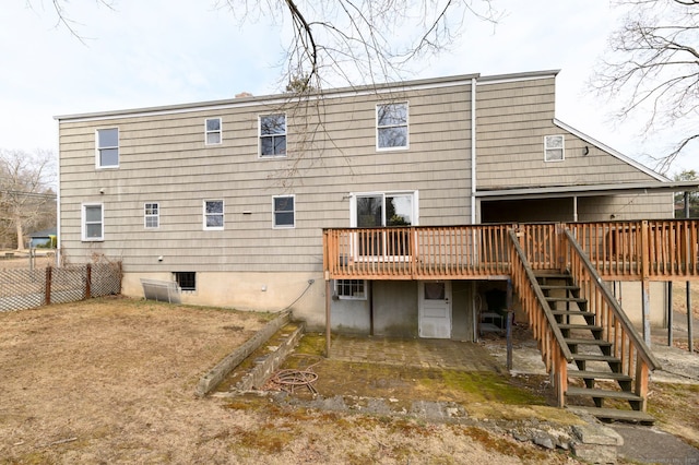 rear view of house featuring fence, a deck, and stairs