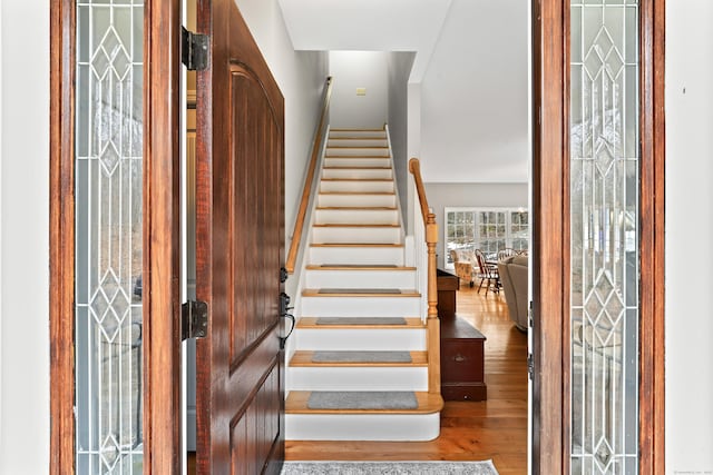 stairway with wood finished floors