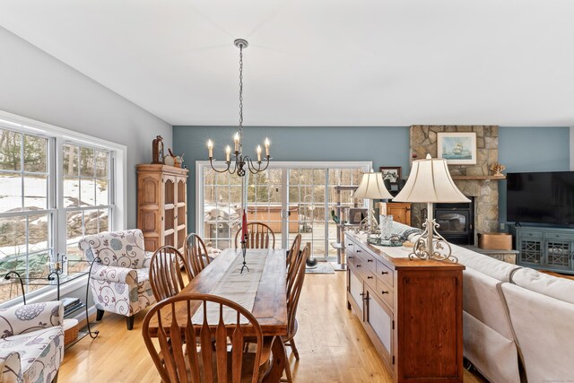 dining area with plenty of natural light, a chandelier, and light wood-type flooring