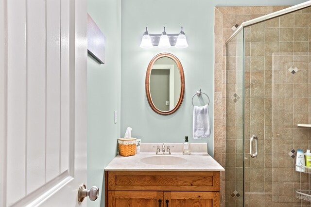bathroom featuring vanity and a shower stall