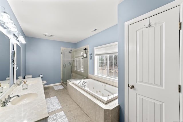bathroom with visible vents, tile patterned flooring, toilet, a jetted tub, and a sink