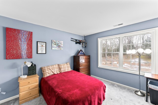 bedroom with baseboards, carpet, and visible vents