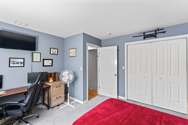 carpeted bedroom with baseboards, visible vents, and a closet