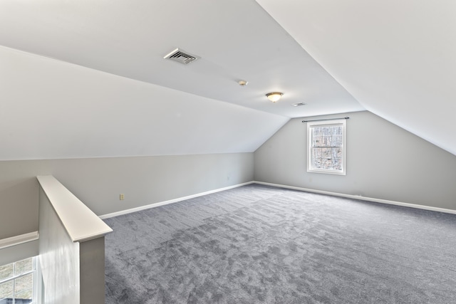bonus room with baseboards, visible vents, carpet, and vaulted ceiling