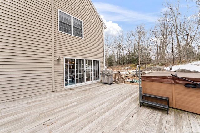 deck with a hot tub and grilling area