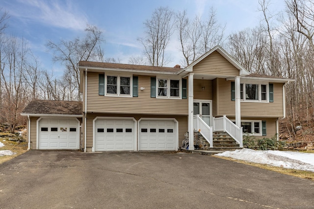 split foyer home with driveway and an attached garage