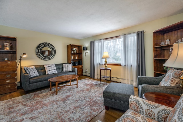 living room with baseboard heating and wood finished floors