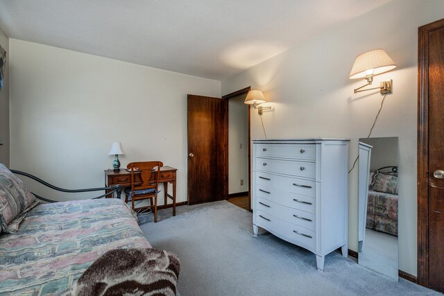 bedroom featuring baseboards and light colored carpet