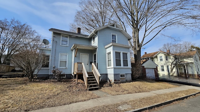 view of front of home featuring a chimney