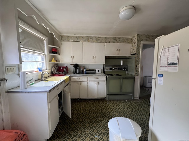 kitchen featuring light countertops, white cabinetry, open shelves, a sink, and range with electric stovetop