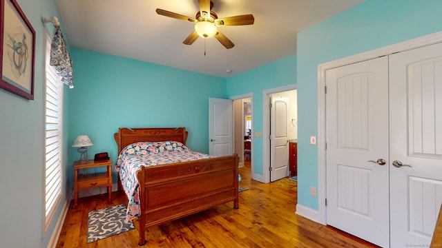 bedroom with a closet, ceiling fan, baseboards, and wood finished floors