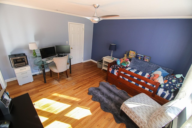 bedroom with baseboards, ornamental molding, and wood finished floors