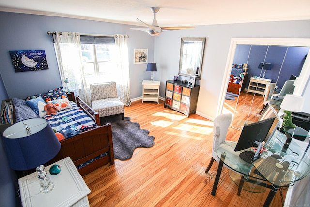 living area with light wood-style floors, ceiling fan, and baseboards