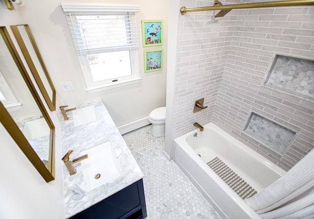 bathroom with double vanity, a baseboard radiator, a sink, and toilet