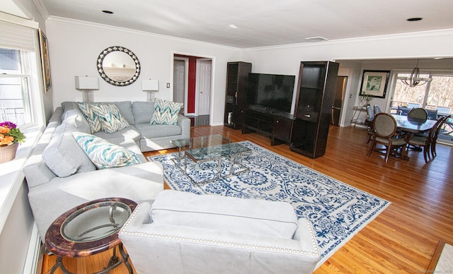 living room featuring crown molding, visible vents, and wood finished floors