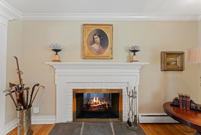 details with baseboards, ornamental molding, wood finished floors, a fireplace, and a baseboard heating unit