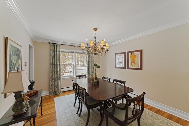 dining space featuring baseboards, light wood-style flooring, ornamental molding, an inviting chandelier, and baseboard heating