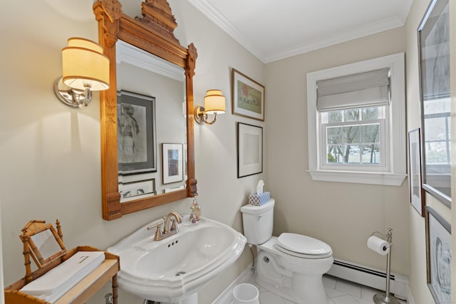 half bathroom with toilet, a baseboard heating unit, a sink, ornamental molding, and tile patterned floors