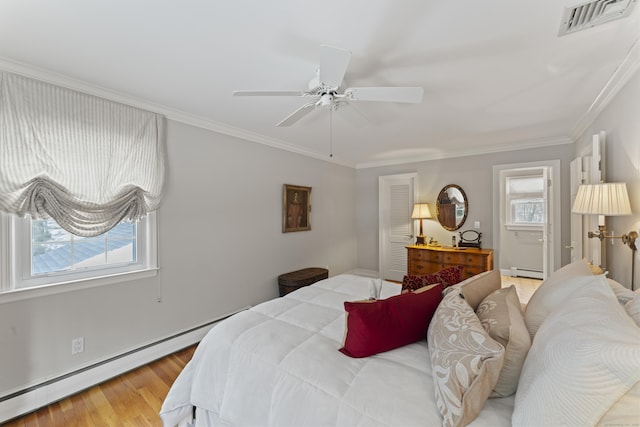 bedroom featuring crown molding, a baseboard radiator, visible vents, a baseboard heating unit, and wood finished floors