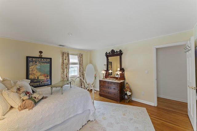 bedroom featuring baseboards and wood finished floors