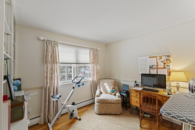 office with a baseboard radiator and wood finished floors