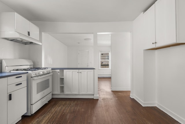 kitchen with dark wood-style floors, a peninsula, white gas stove, under cabinet range hood, and white cabinetry