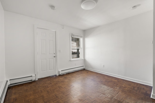 unfurnished room featuring a baseboard radiator and baseboards