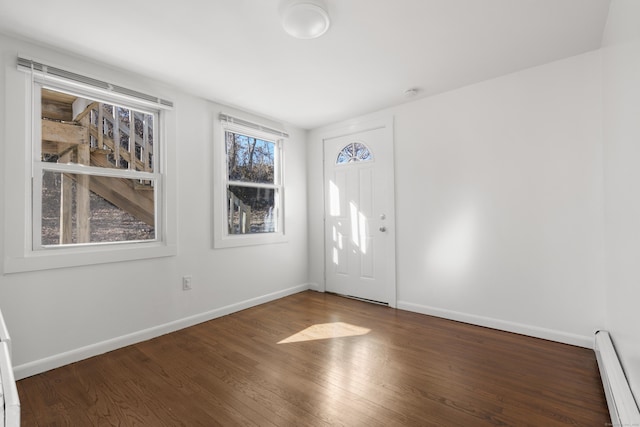 foyer entrance with baseboards, baseboard heating, and wood finished floors