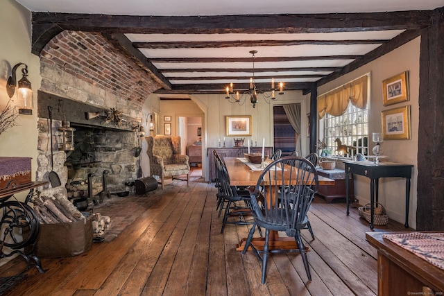 579 Taugwonk Rd, Stonington, CT 06378 - dining space featuring wood-type flooring, a chandelier, beam ceiling, and arched walkways