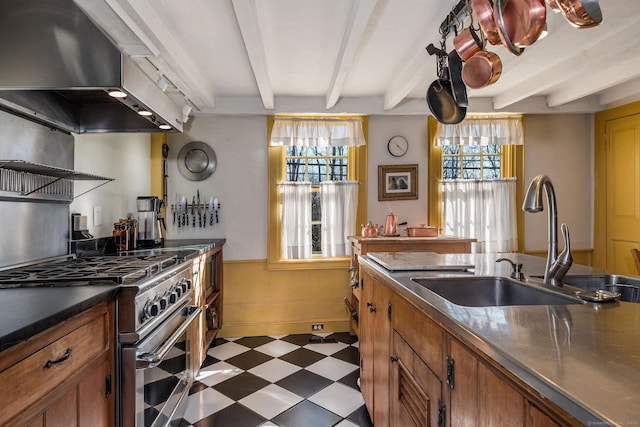 579 Taugwonk Rd, Stonington, CT 06378 - kitchen with high end stainless steel range, dark floors, beam ceiling, exhaust hood, and plenty of natural light