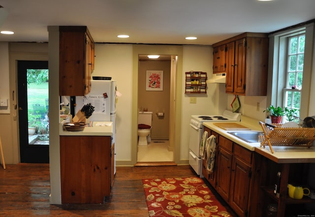 579 Taugwonk Rd, Stonington, CT 06378 - kitchen with white appliances, under cabinet range hood, light countertops, dark wood-style floors, and recessed lighting