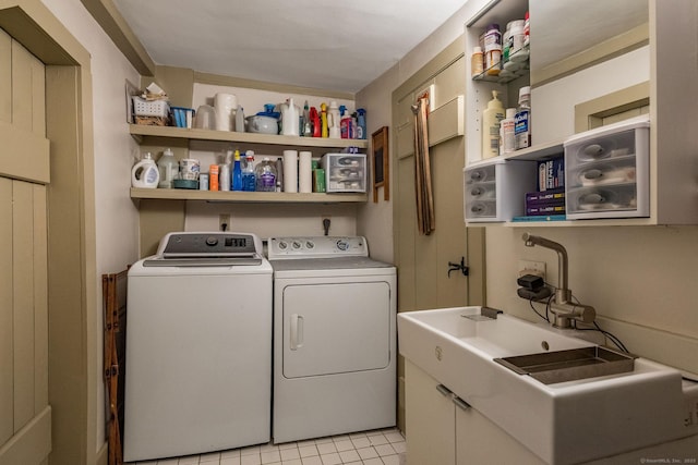 579 Taugwonk Rd, Stonington, CT 06378 - laundry room featuring separate washer and dryer, cabinet space, and light tile patterned flooring
