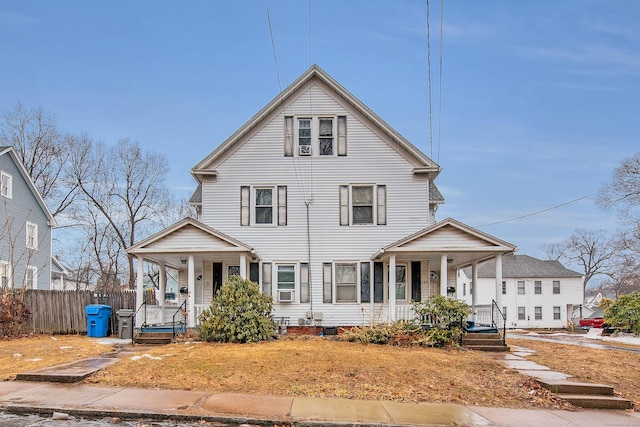 view of front of property featuring covered porch and fence