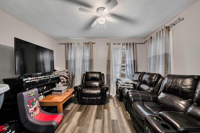 living area with ceiling fan and wood finished floors