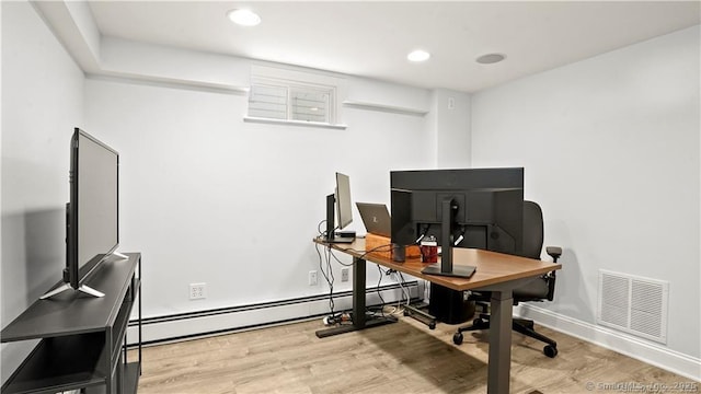 office area with light wood-style flooring, visible vents, baseboard heating, and recessed lighting