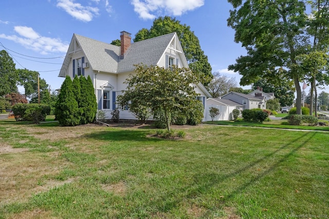 view of front of home with a chimney, a front lawn, and roof with shingles