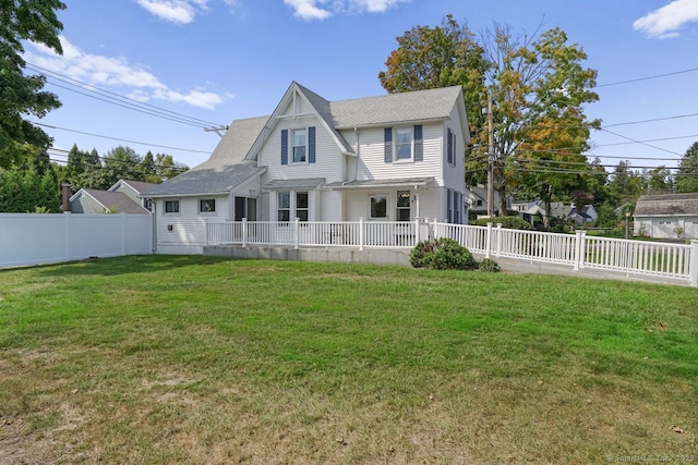 view of front of home with a fenced backyard and a front lawn