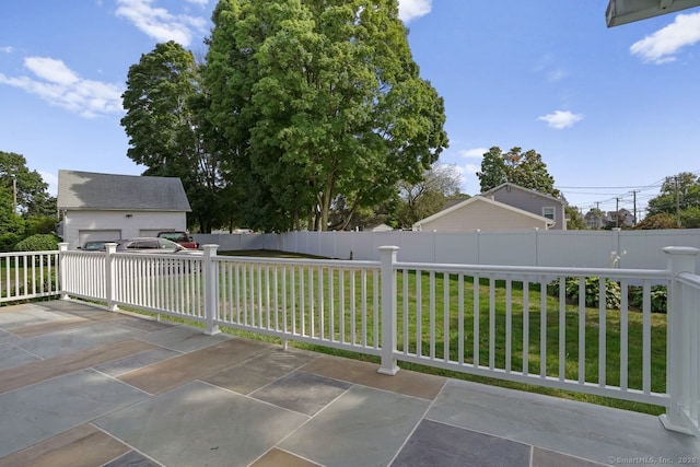 view of patio / terrace featuring an outbuilding and fence