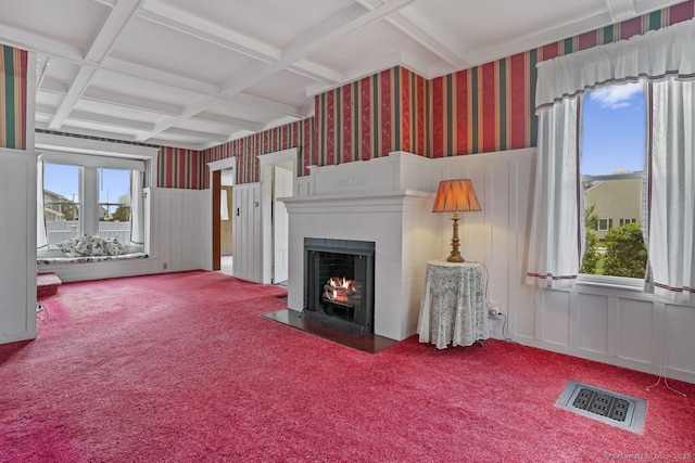 unfurnished living room featuring wallpapered walls, carpet, visible vents, and coffered ceiling